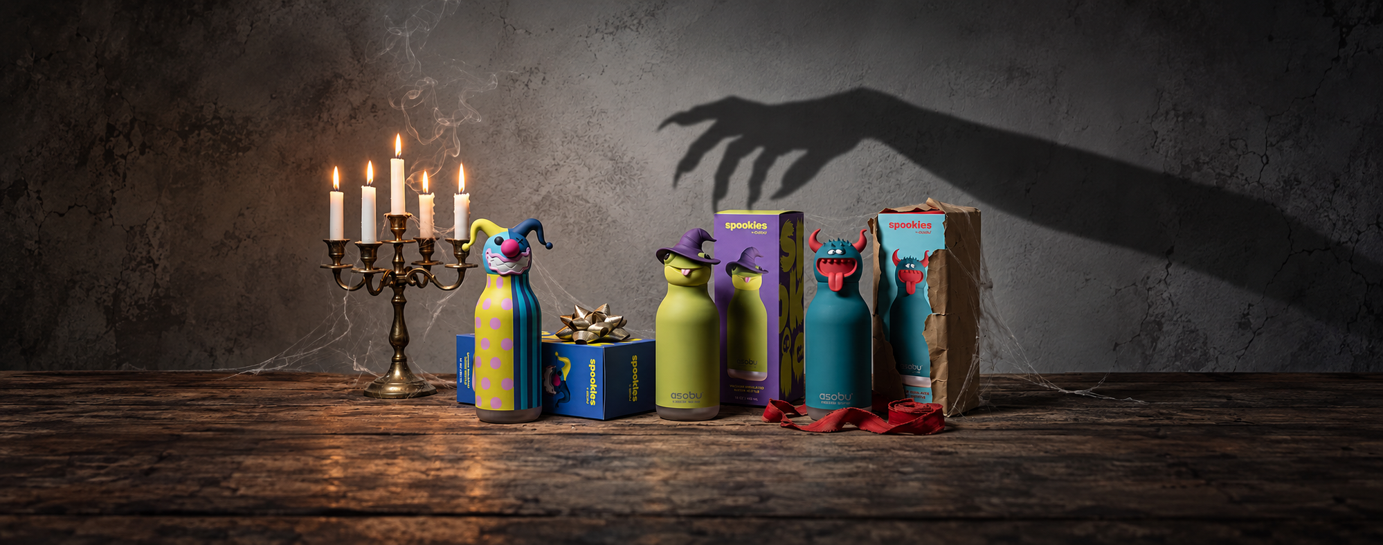 Spookies clown, witch and beast with gift boxes and candles.